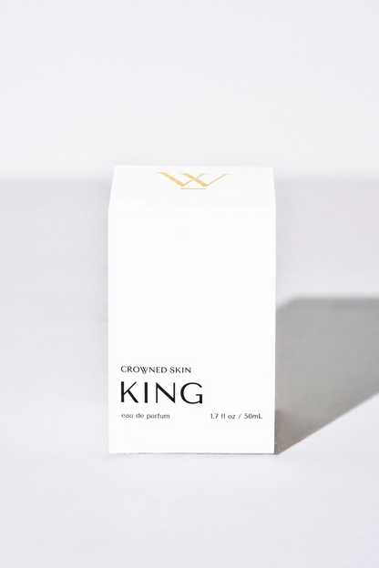 Crowned Skin King Eau de Parfum bottle displayed elegantly — a luxury men's fragrance featuring notes of Mandarin, Patchouli, Dark Vanilla, and Musk.
