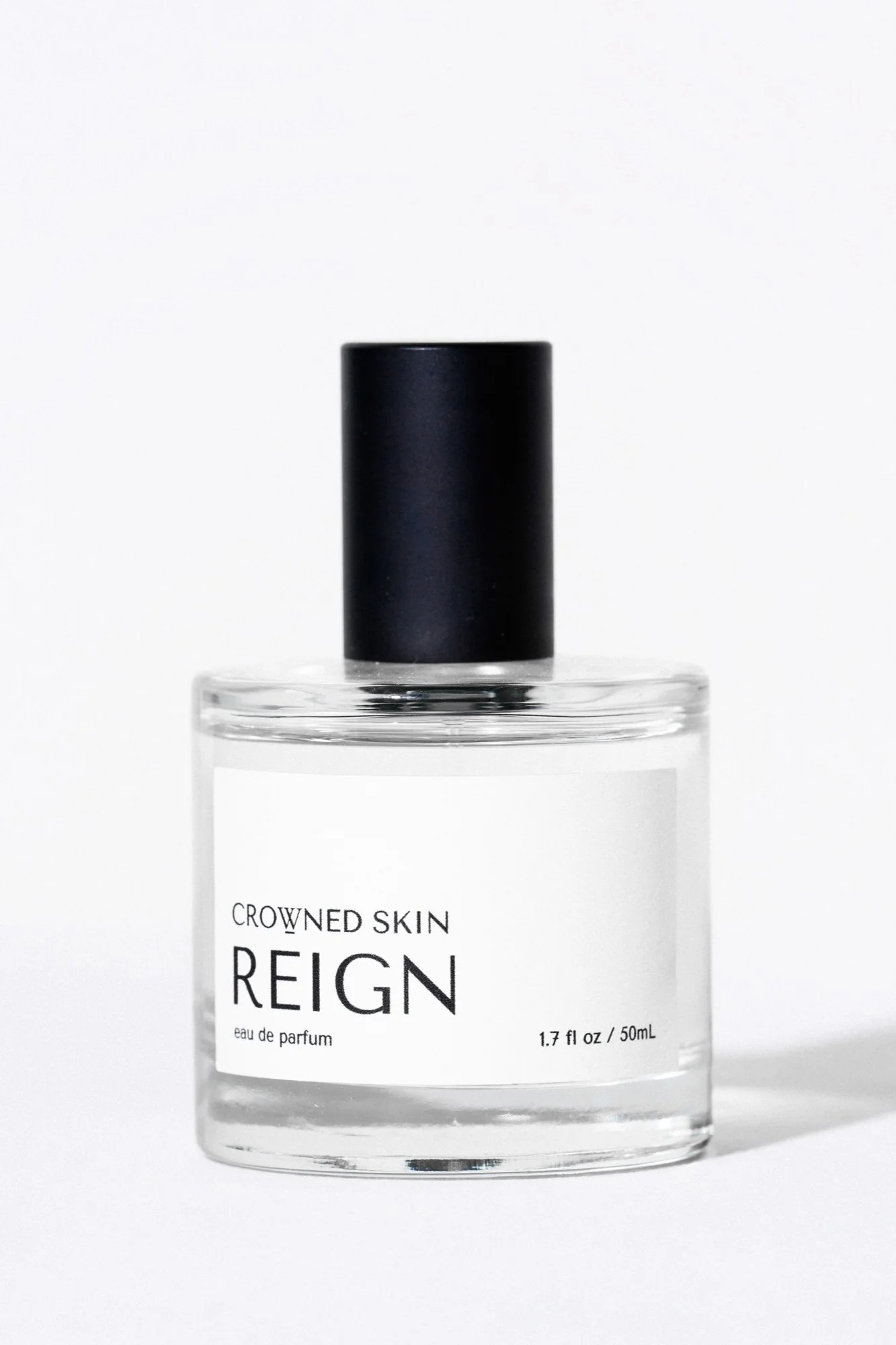 Crowned Skin Reign Eau de Parfum bottle — a fresh luxury men's fragrance featuring notes of Bergamot, Jasmine, Eucalyptus, and Amber Mist.