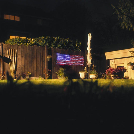 420 LED solar powered American flag string lights displayed on a yard fence for 4th of July decoration