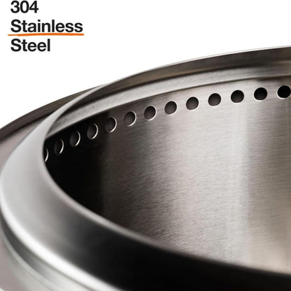 Solo Stove Yukon 2.0 stainless steel smokeless fire pit with stand glowing with a wood fire in a backyard at night