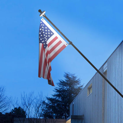 5 foot black stainless steel flag pole kit with solar light and embroidered American flag mounted on a residential home