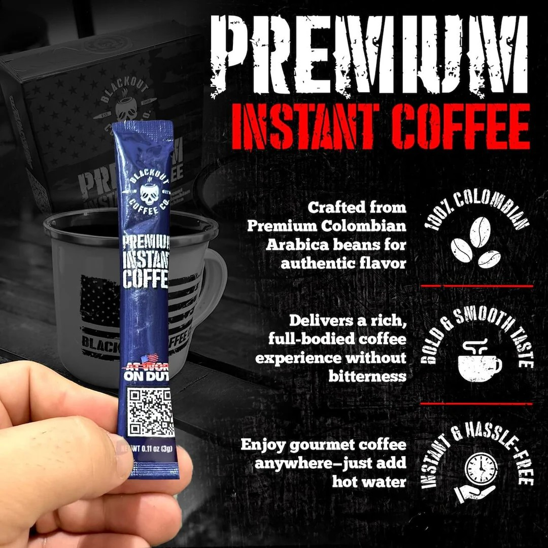 Blackout Coffee instant coffee single serve packs laid out on a rugged outdoor surface with an American flag in the background