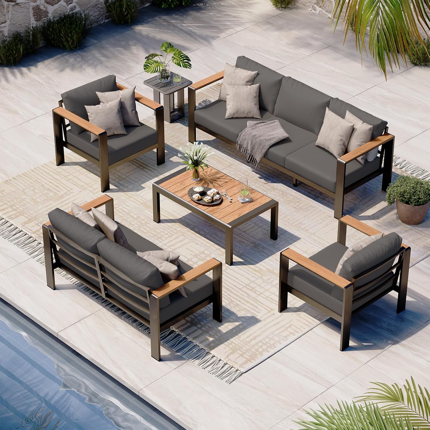 Oasbira 5-piece aluminum patio furniture set in graphite with thick cushioned sectional sofa and coffee table set up on backyard deck