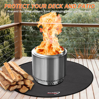 Solo Stove Yukon 2.0 stainless steel smokeless fire pit with stand glowing with a wood fire in a backyard at night