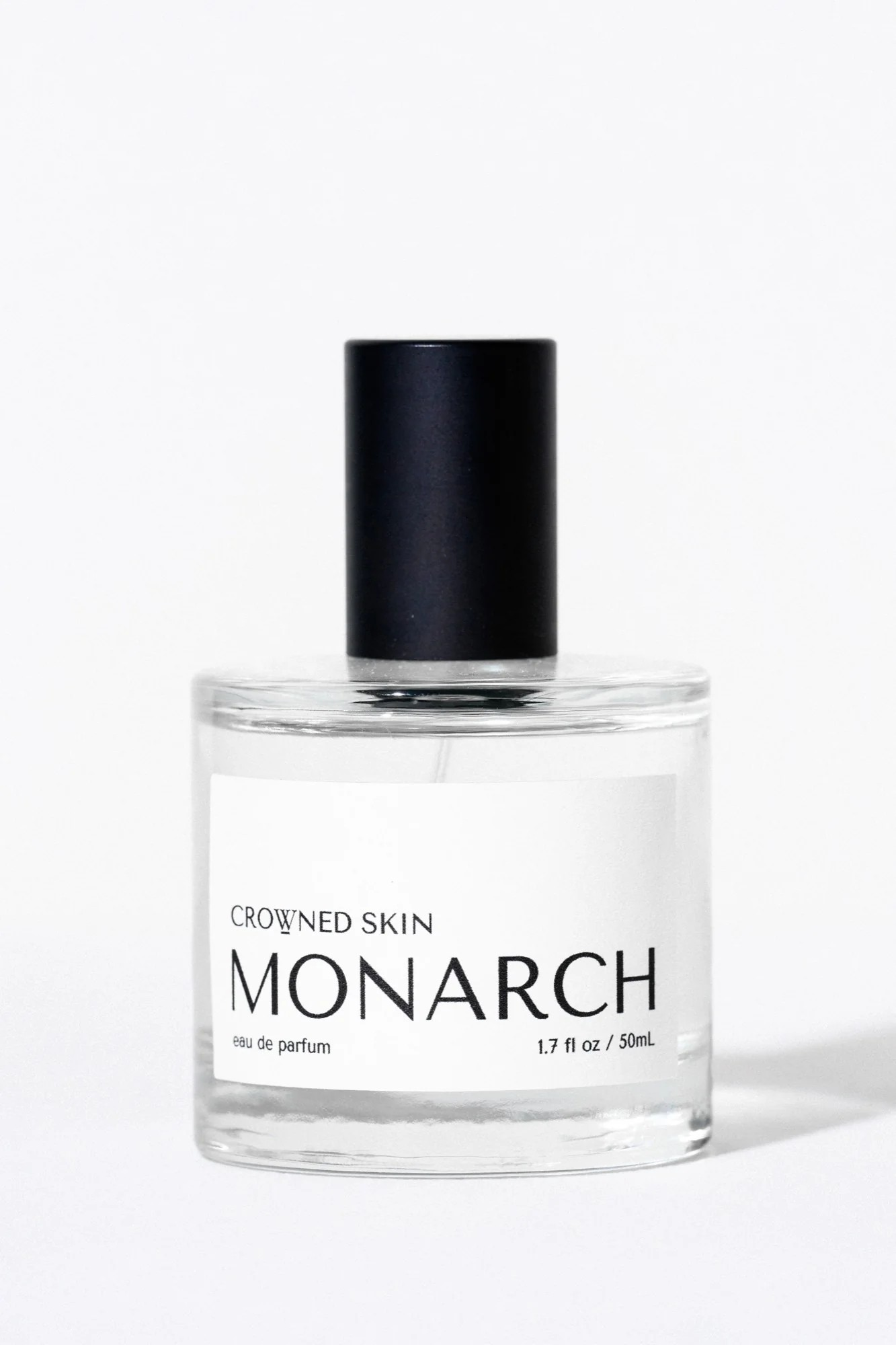 Crowned Skin Monarch Eau de Parfum bottle — a bold luxury men's fragrance featuring notes of Bergamot, Smoked Sage, Cedar, and Sandalwood.