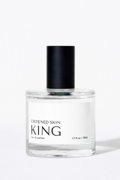 Crowned Skin King Eau de Parfum bottle displayed elegantly — a luxury men's fragrance featuring notes of Mandarin, Patchouli, Dark Vanilla, and Musk.