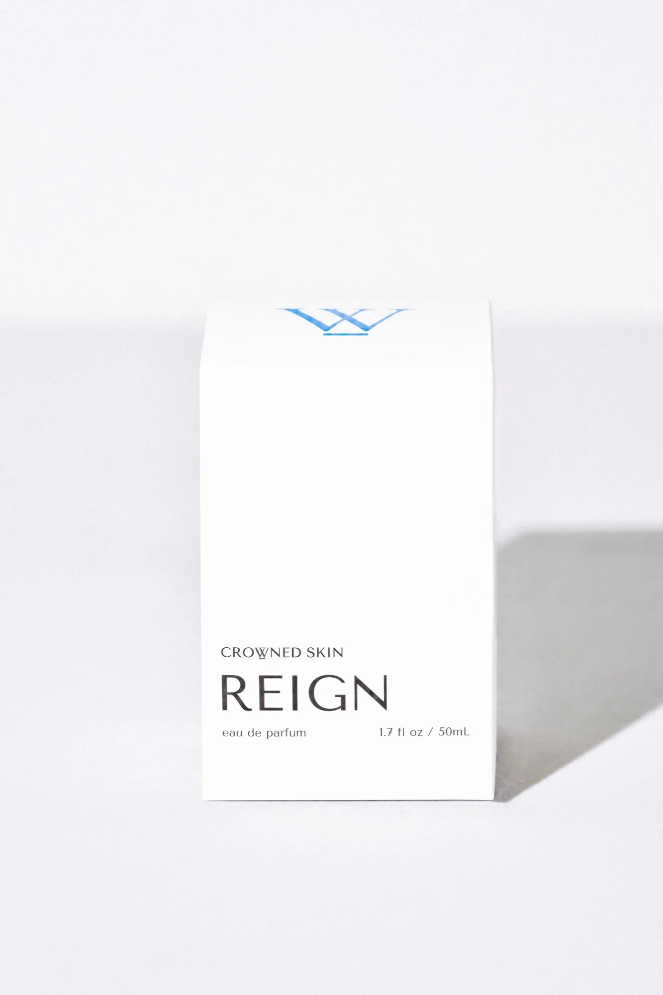 Crowned Skin Reign Eau de Parfum bottle — a fresh luxury men's fragrance featuring notes of Bergamot, Jasmine, Eucalyptus, and Amber Mist.