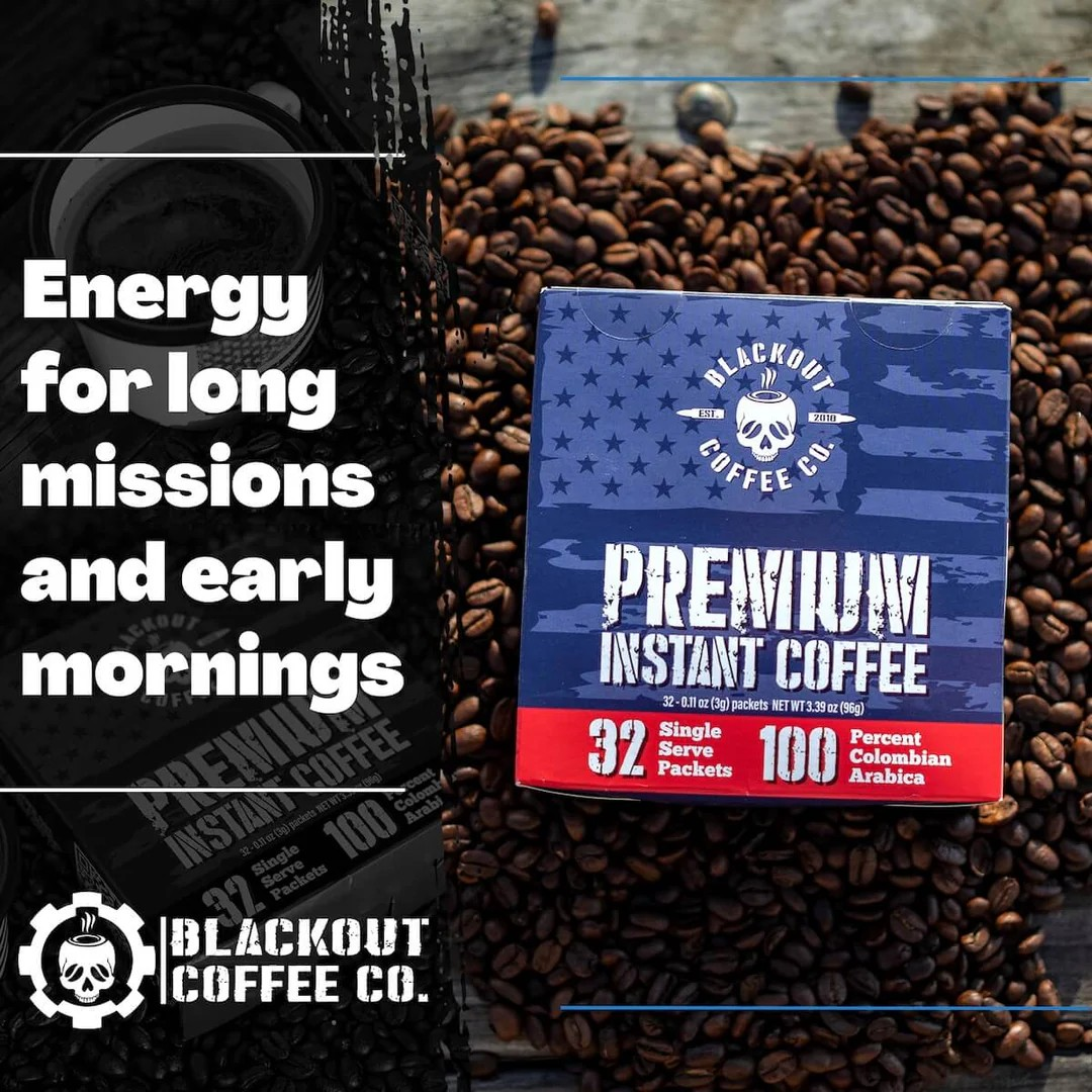 Blackout Coffee instant coffee single serve packs laid out on a rugged outdoor surface with an American flag in the background