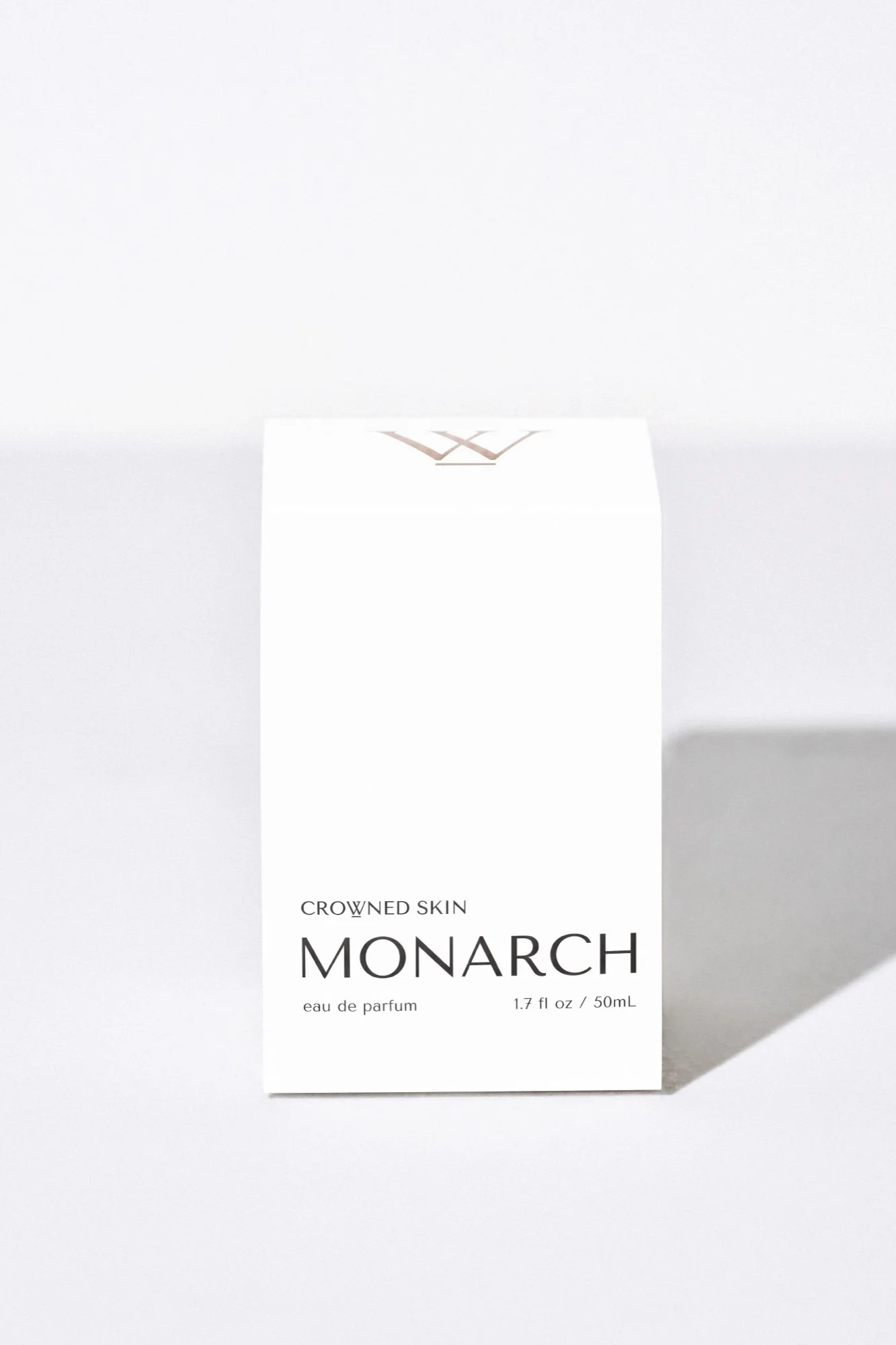 Crowned Skin Monarch Eau de Parfum bottle — a bold luxury men's fragrance featuring notes of Bergamot, Smoked Sage, Cedar, and Sandalwood.