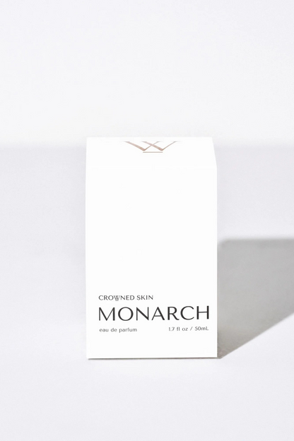 Crowned Skin Monarch Eau de Parfum bottle — a bold luxury men's fragrance featuring notes of Bergamot, Smoked Sage, Cedar, and Sandalwood.